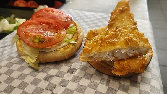 Crispy fish burger with tartare on gingham paper